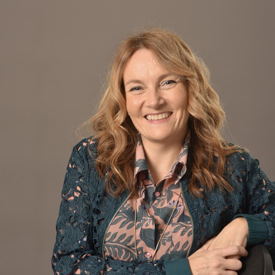 Head of Design Sarah Lloyd smiles confidently, showcasing her expertise in trend-led technical fabric design at Panaz.