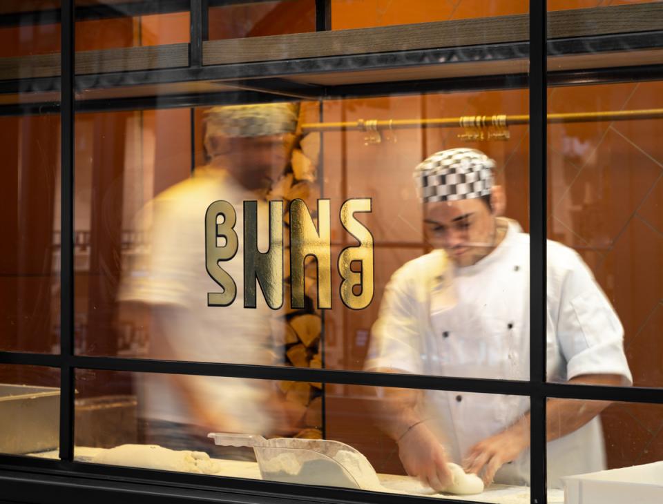 Chefs preparing dough inside the vibrant Buns & Buns restaurant in Covent Garden, showcasing the eclectic design by Michaelis Boyd.