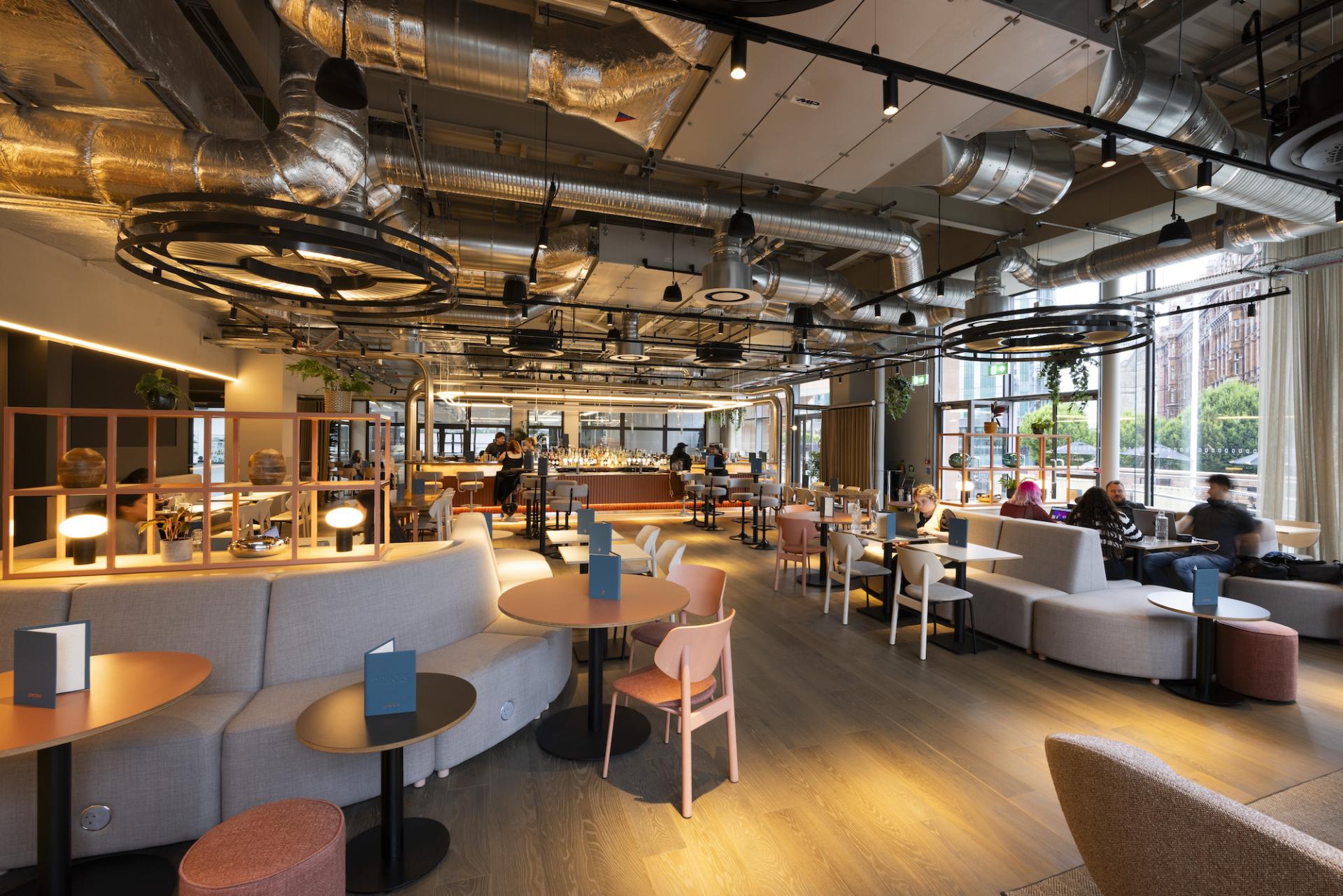 Trendy café interior at Manchester Central, featuring modern furnishings and dynamic lighting for a vibrant atmosphere.