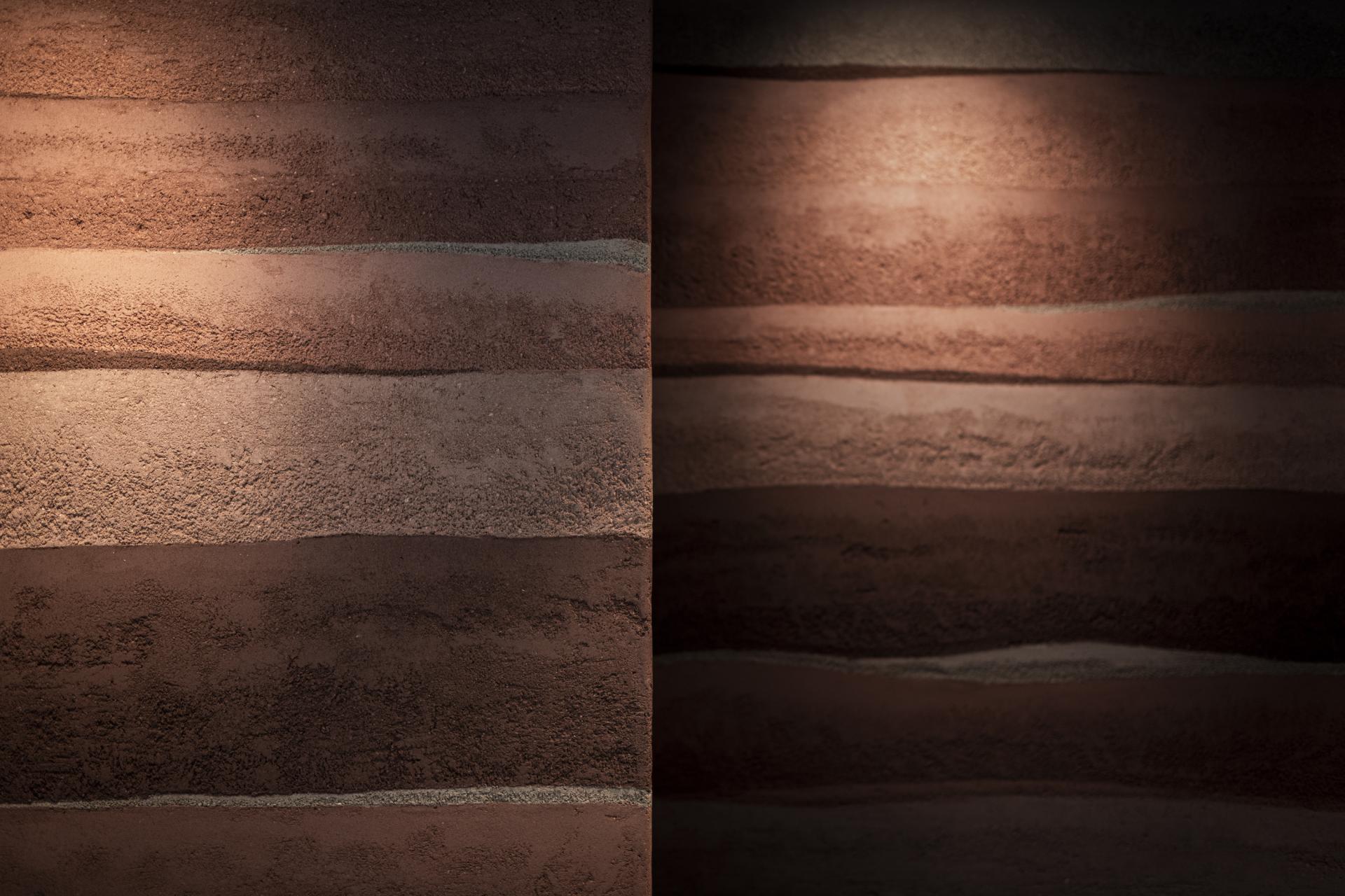Textured wall finishes in warm earth tones, showcasing Clayworks' sustainable Rammed Earth design inspired by natural materials.