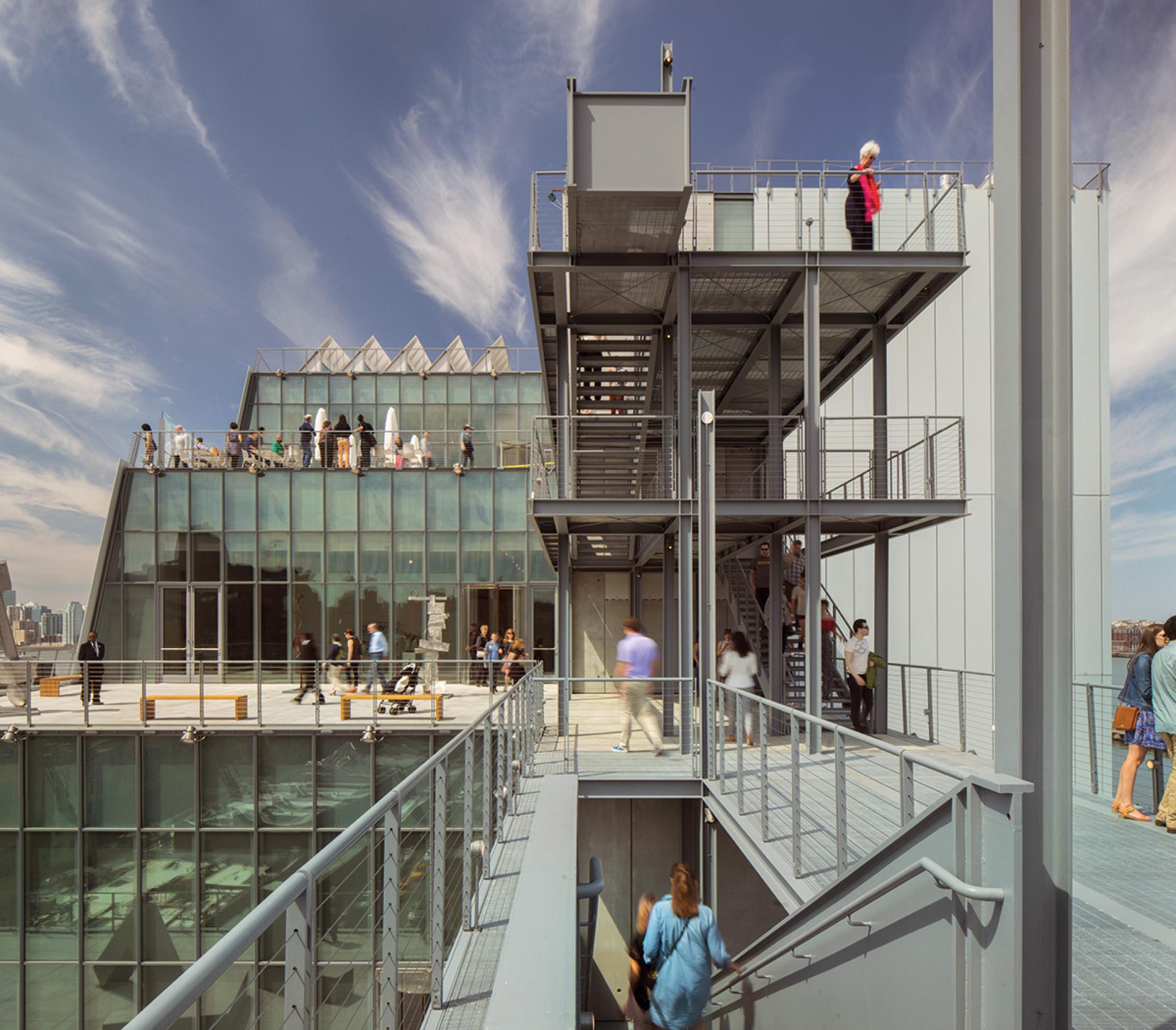 Renzo Piano's modern architectural design showcases visitors exploring a glass and metal building with panoramic views.