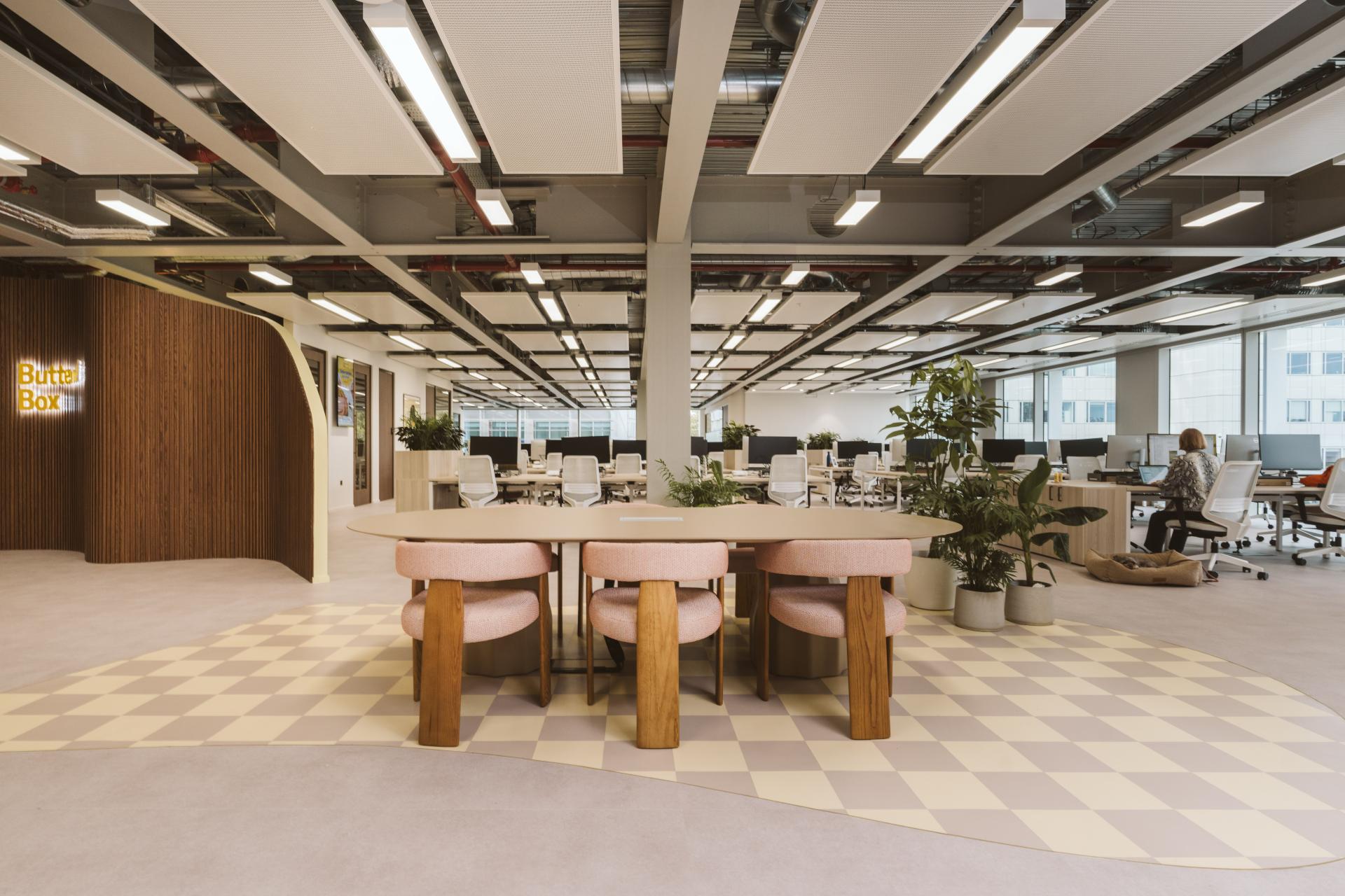 Modern workspace design for Butternut Box featuring collaborative areas, stylish furniture, plants, and accessible dog-friendly spaces.