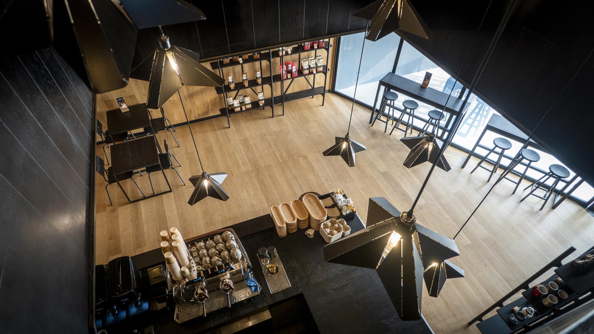 Stylish interior of Brew92 coffee shop featuring modern lighting, minimalist furniture, and a coffee bar by Liqui Group.