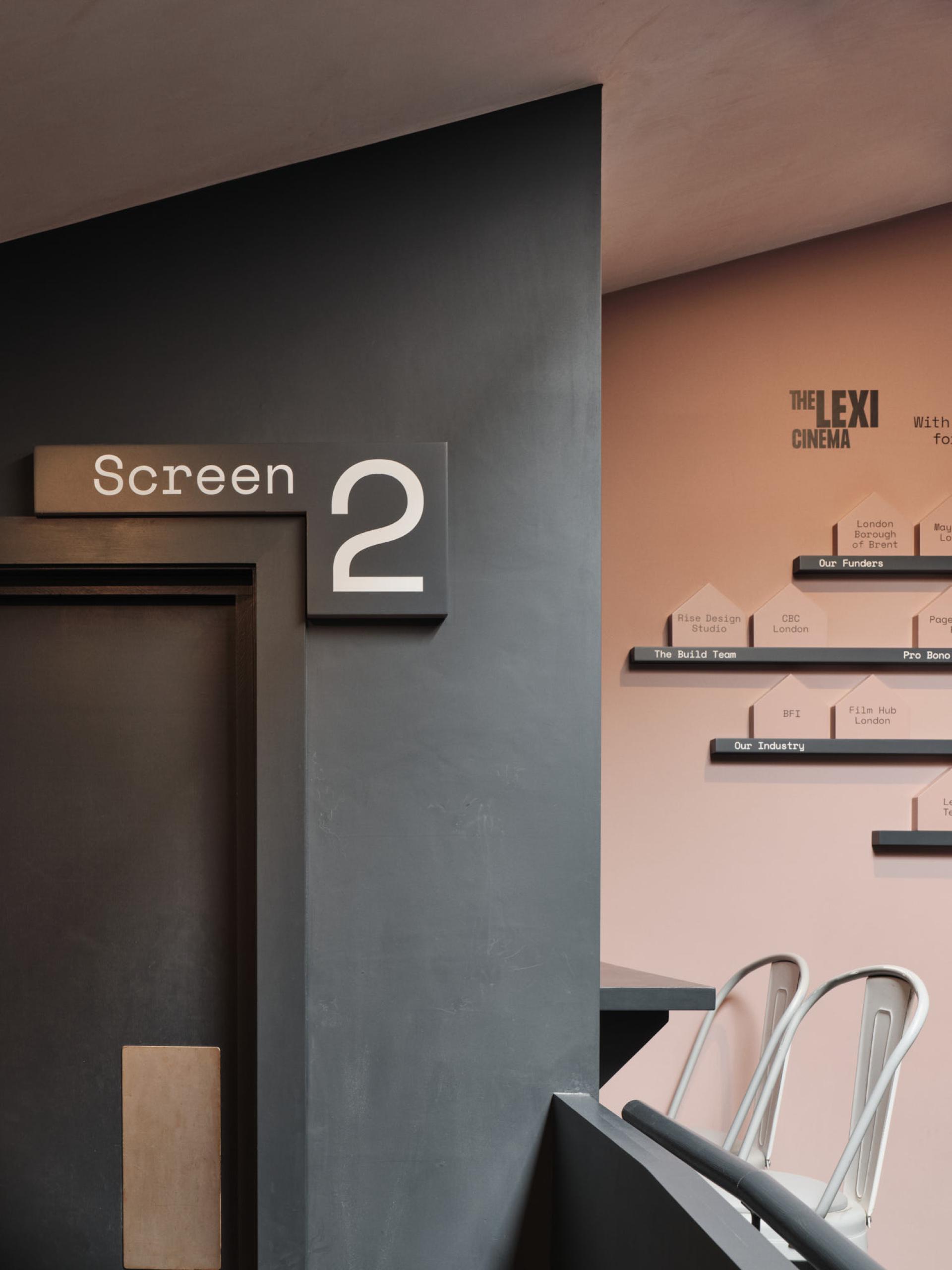 Modern cinema interior featuring 'Screen 2' signage at The Lexi, a social enterprise cinema in London.