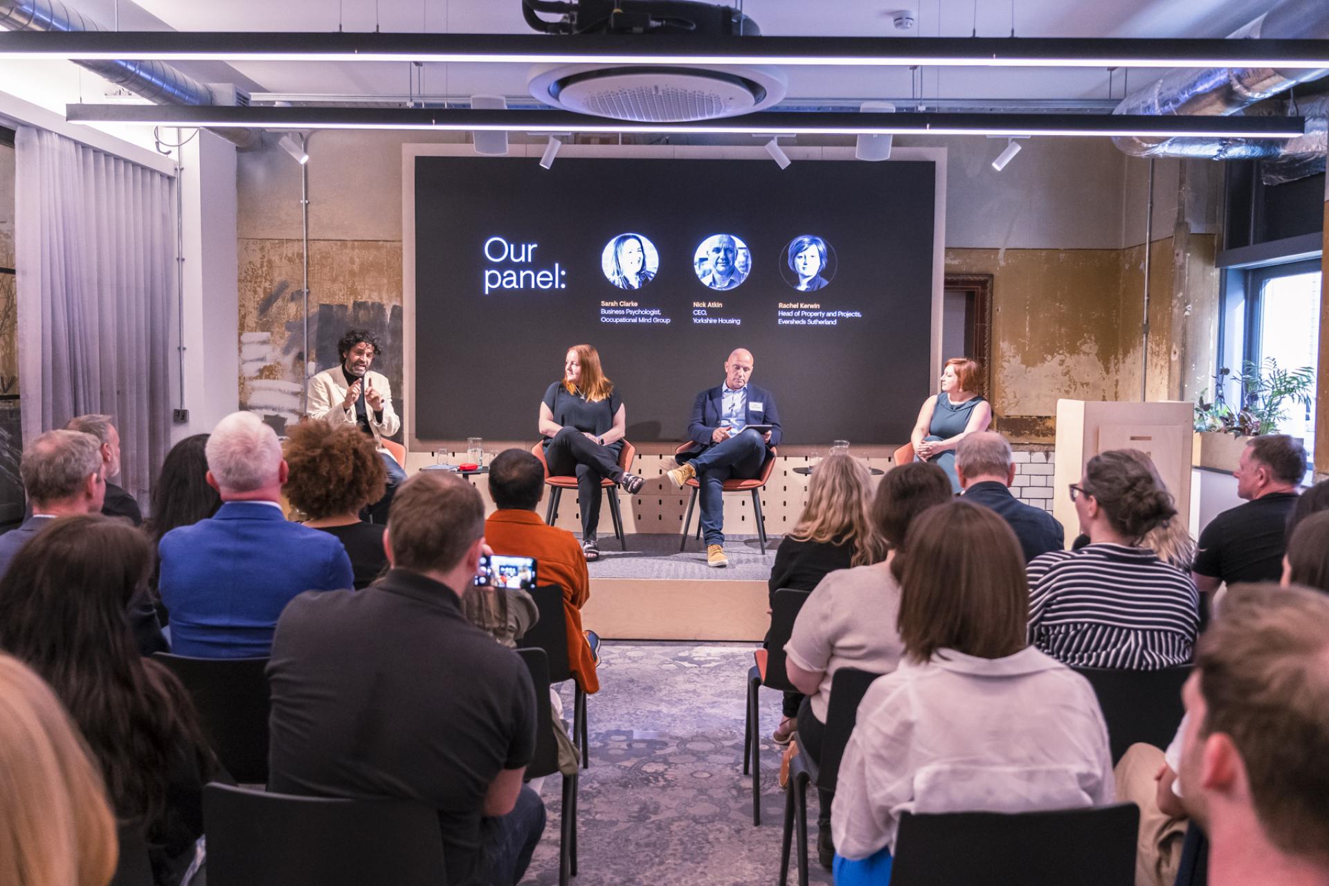 Panel discussion on the Future of Workplace featuring experts sharing insights with a diverse audience.