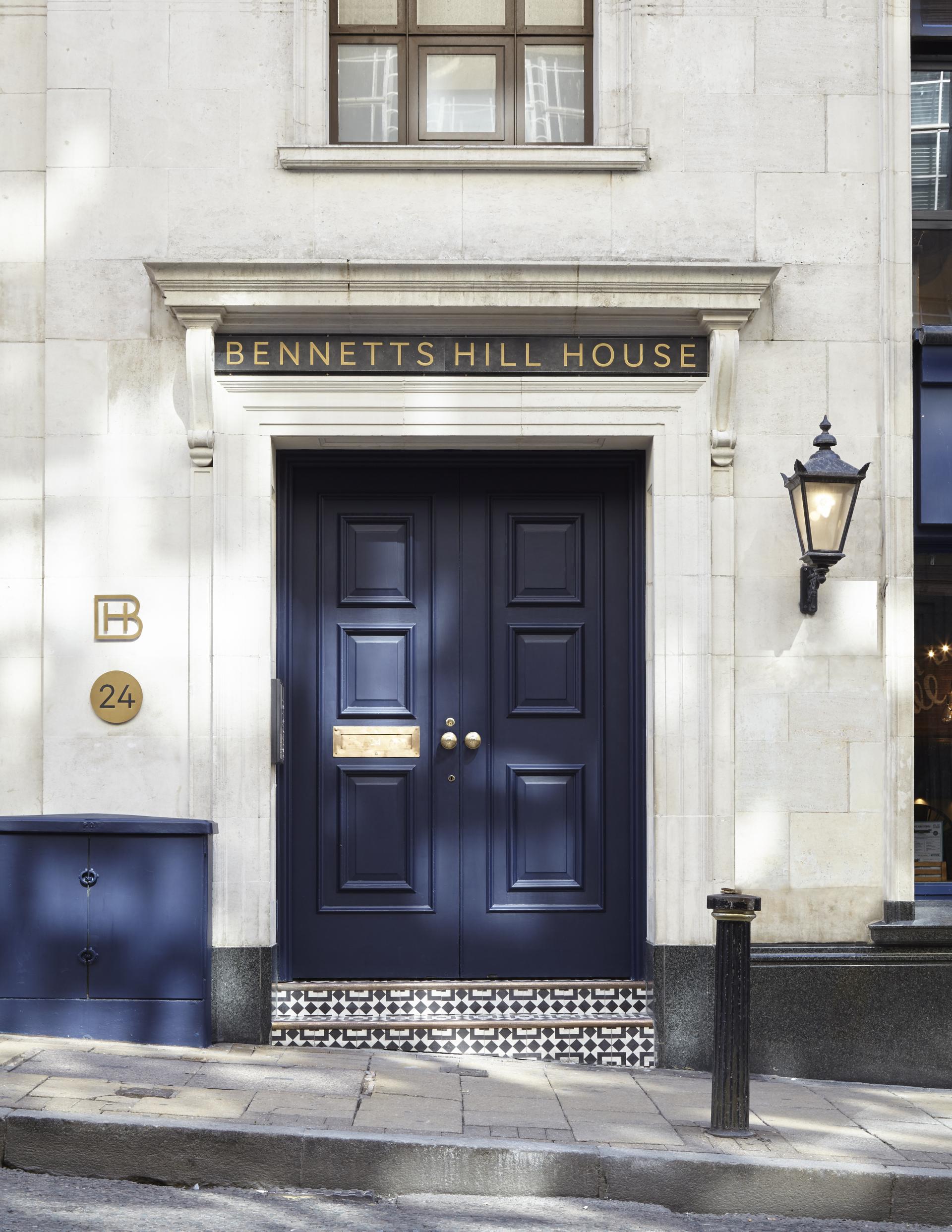 Stylish entrance of Bennetts Hill House featuring navy doors and decorative tiled base, showcasing modern office transformation.