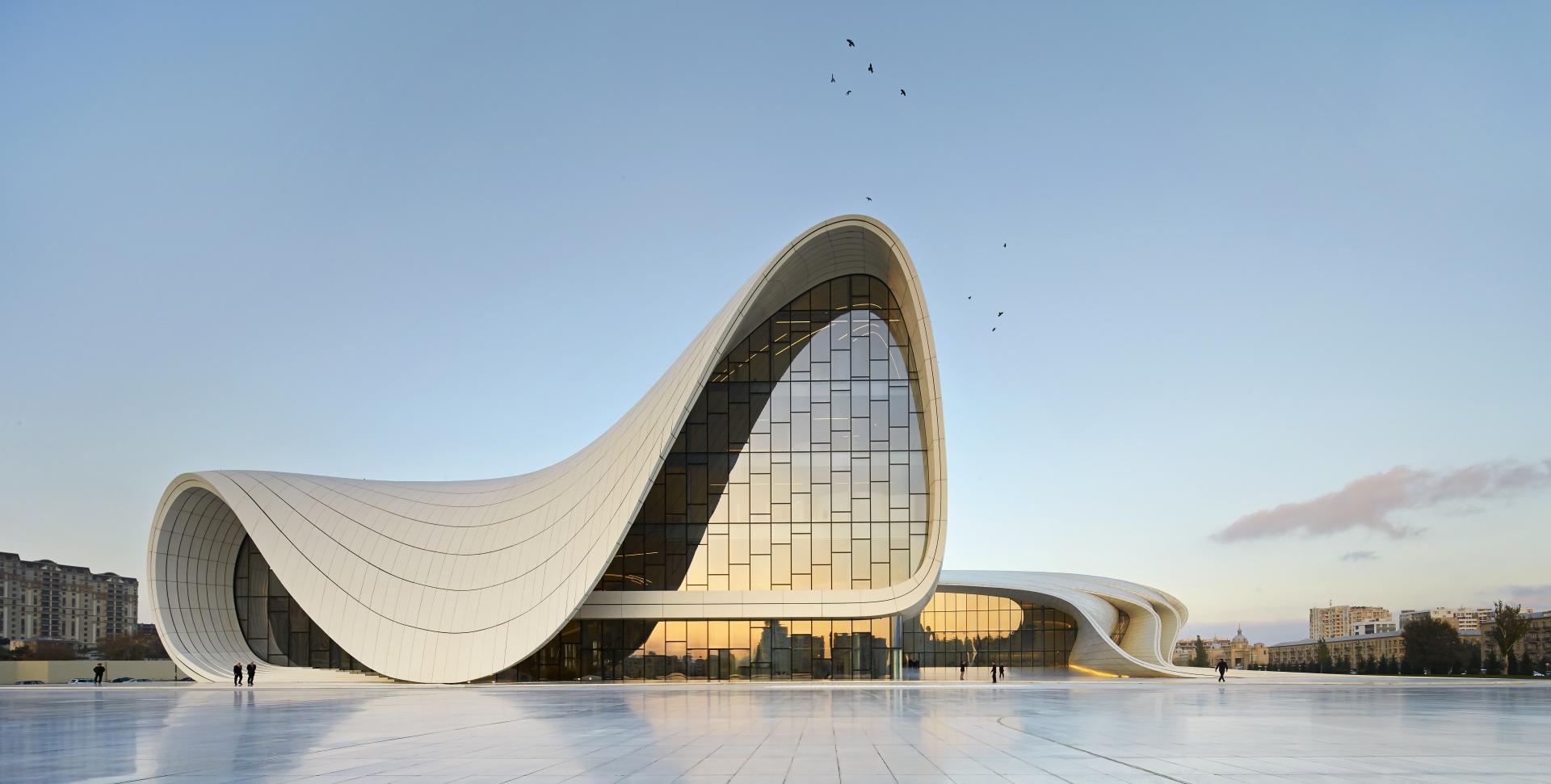 Sleek modern architecture of the Heydar Aliyev Center in Azerbaijan, showcasing Zaha Hadid's iconic design style.