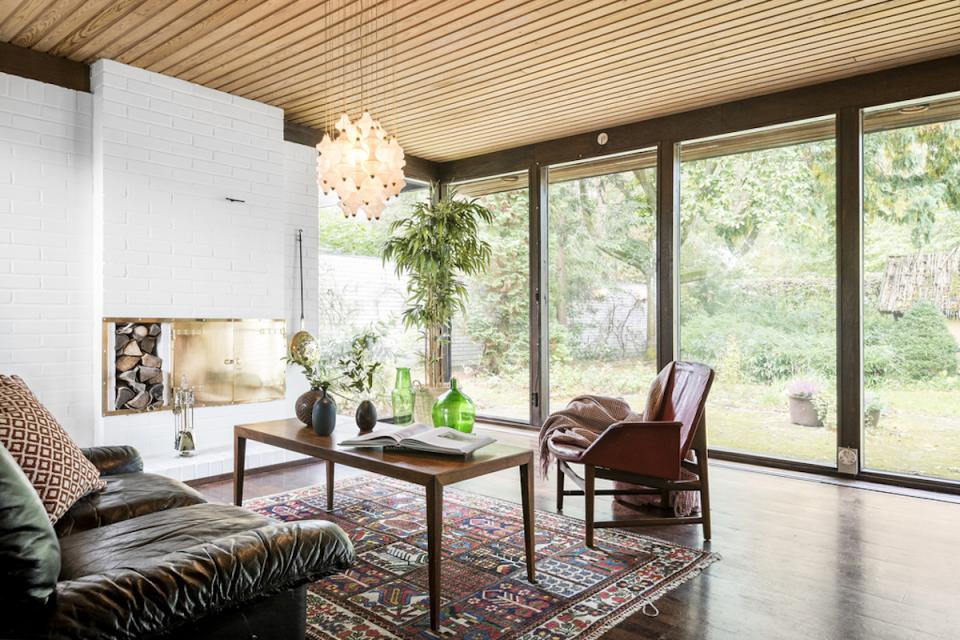 Stylish Scandinavian living room featuring large windows, modern decor, and a cozy atmosphere showcasing Swedish design principles.