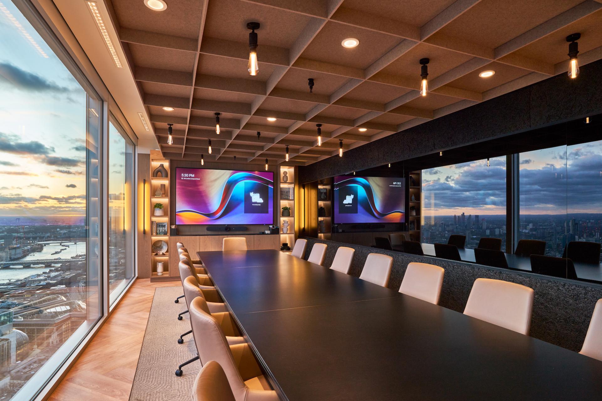 Modern conference room design featuring sleek furniture and digital displays, showcasing Bentley Systems’ innovative workspace.