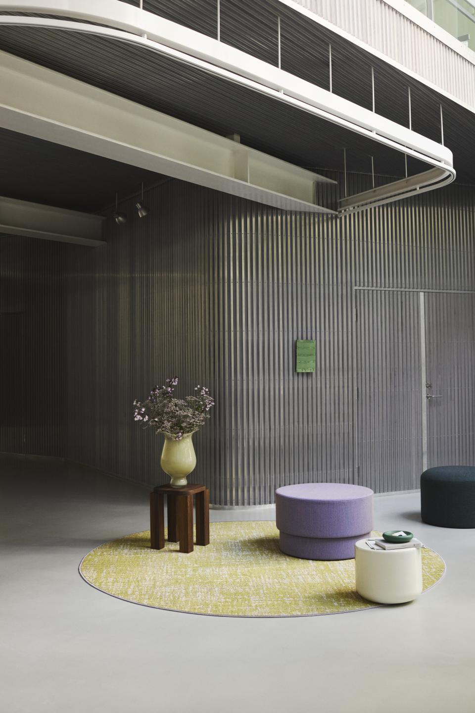 Modern interior showcasing Ege's ReForm Memory carpet design with seating, promoting a tranquil and stylish atmosphere.