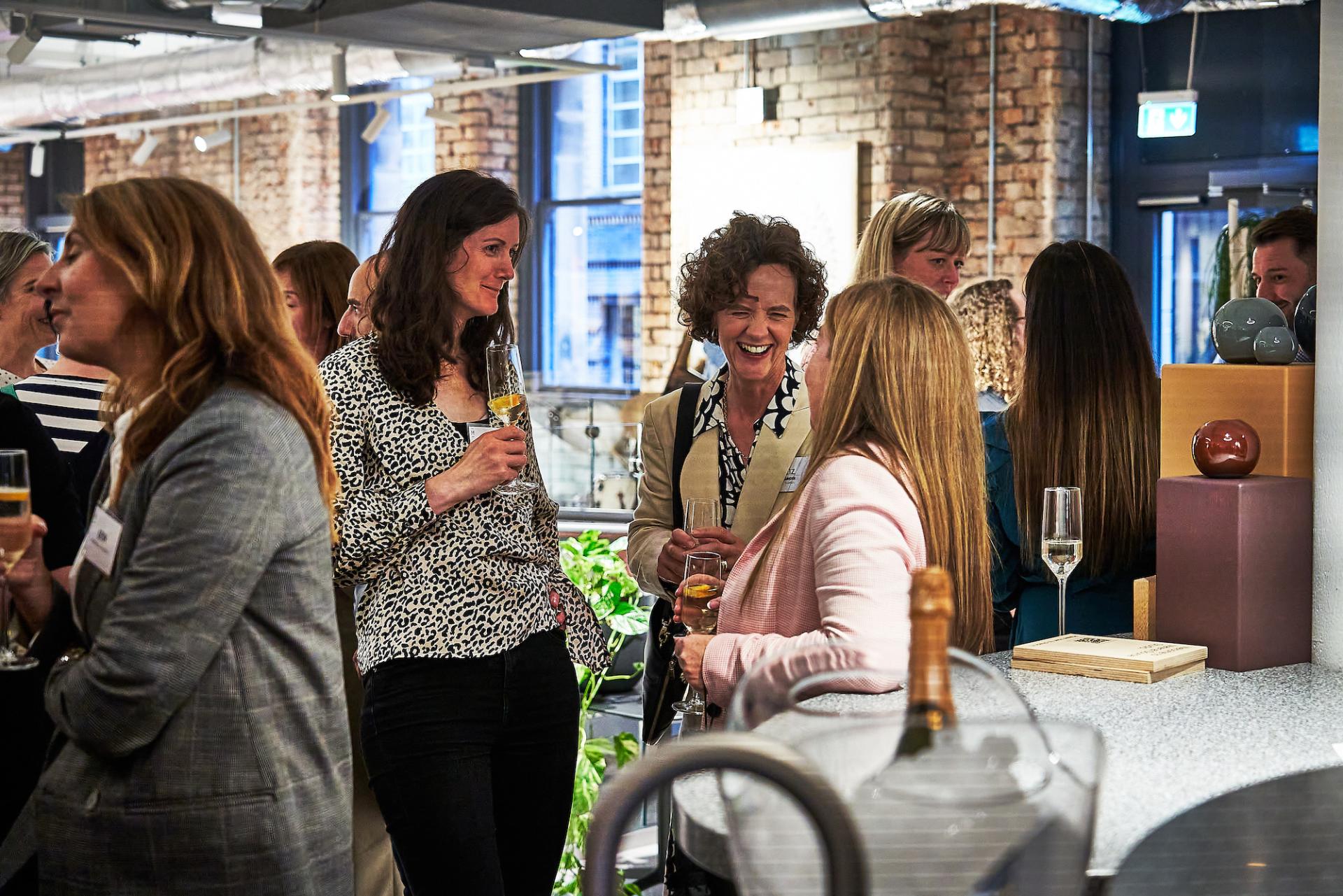 Guests celebrate and network at the 42 Gathering event, marking the conclusion of the "42 Roles in the Built Environment" podcast.