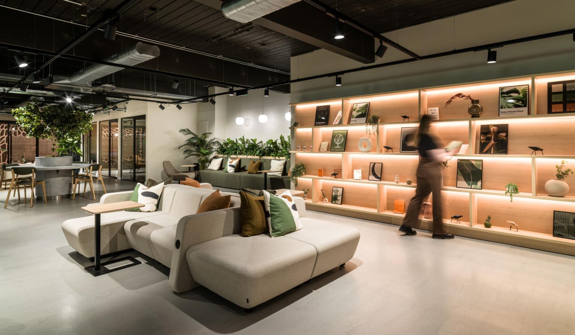 Stylish lounge area featuring modern seating, greenery, and a well-lit display shelf, showcasing the Nest concept at Alderley Park.