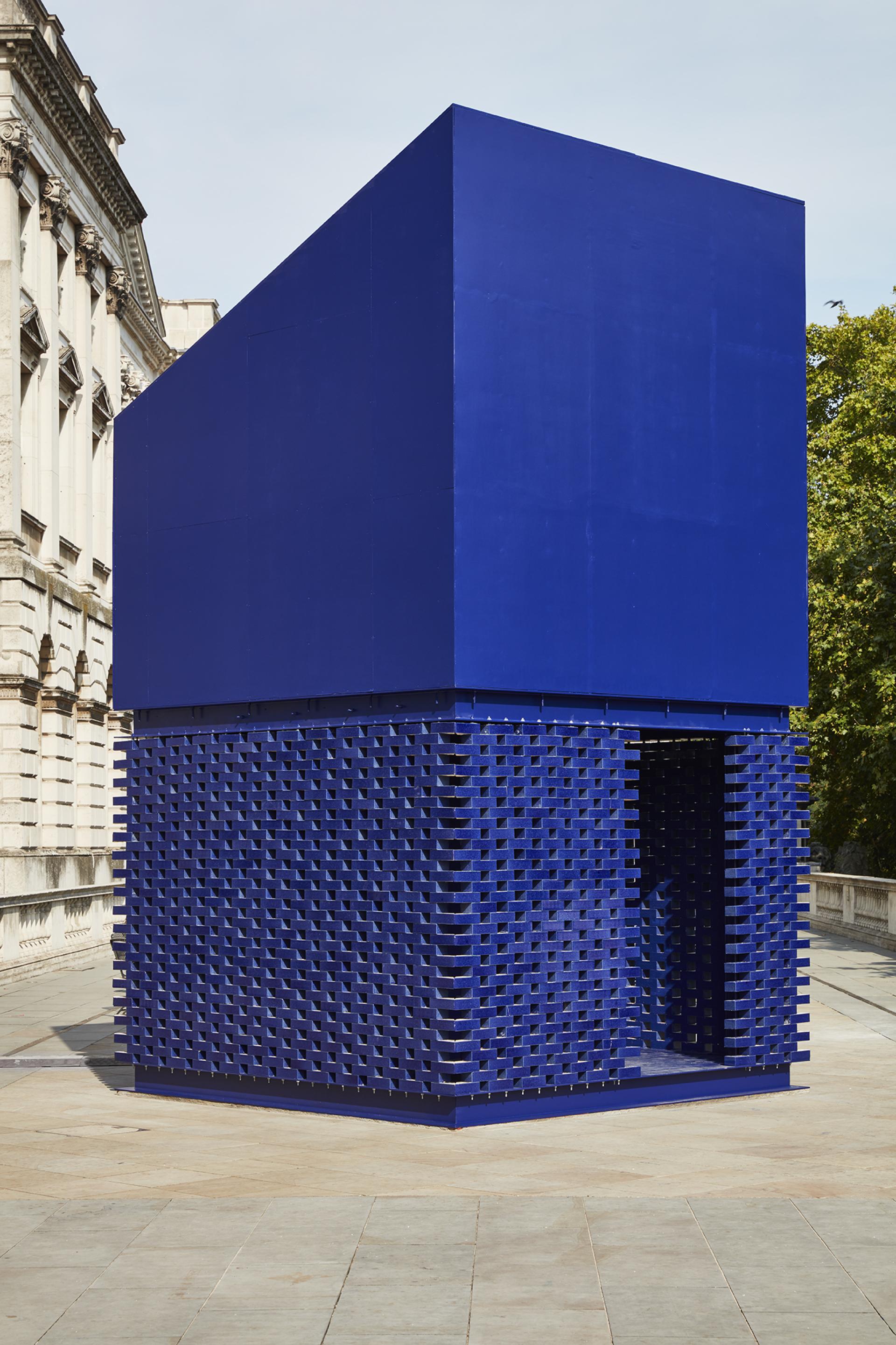 Bold blue geometric installation displayed at the London Design Biennale outside Somerset House, showcasing innovative architecture.