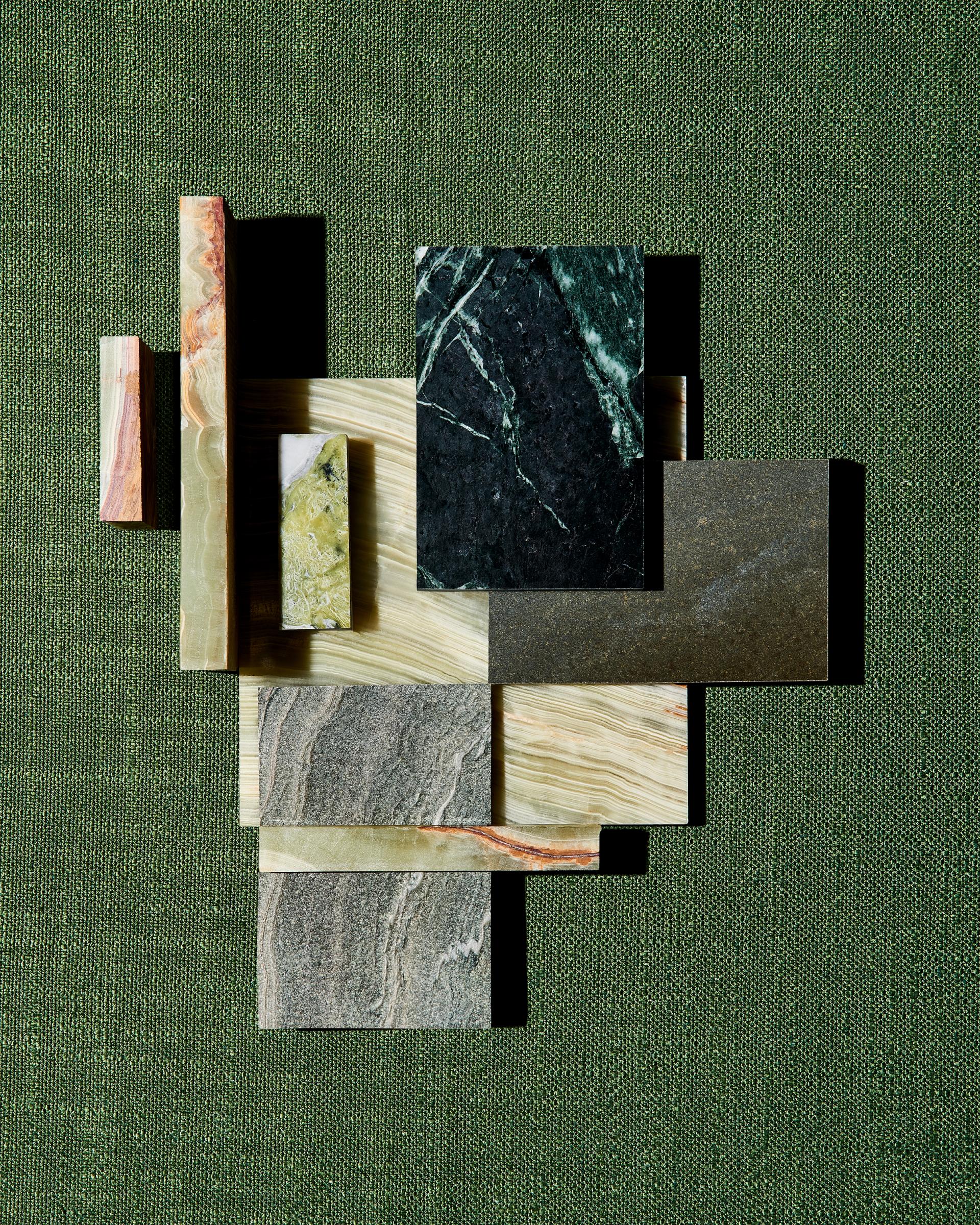Natural stone samples from SolidNature's Green Stone Collection displayed against a textured green background.