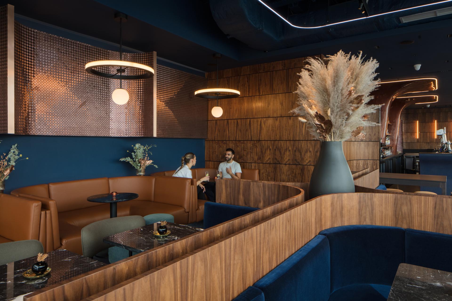 Contemporary interior of M'Arks Sky Bar, featuring elegant seating, stylish decor, and patrons enjoying drinks in London.