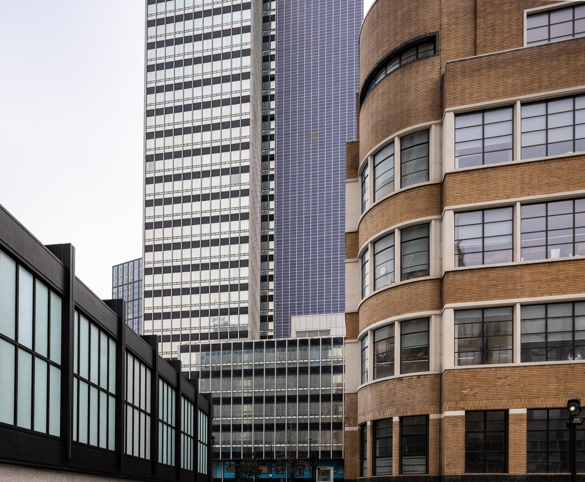Modern and historic buildings merge in the vibrant New Century venue, highlighting community transformation and urban development.