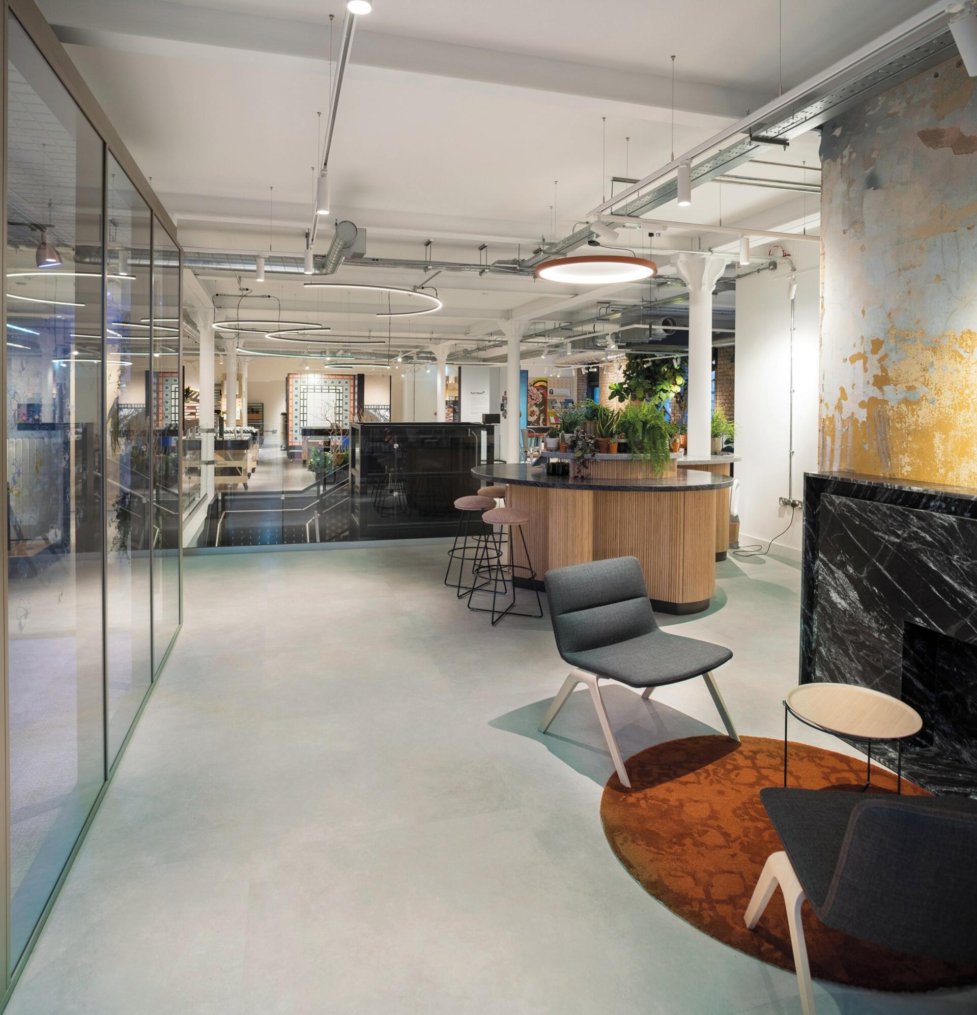 Stylish office space featuring Karndean Designflooring's extra-large concrete-look tiles, modern furniture, and natural greenery.