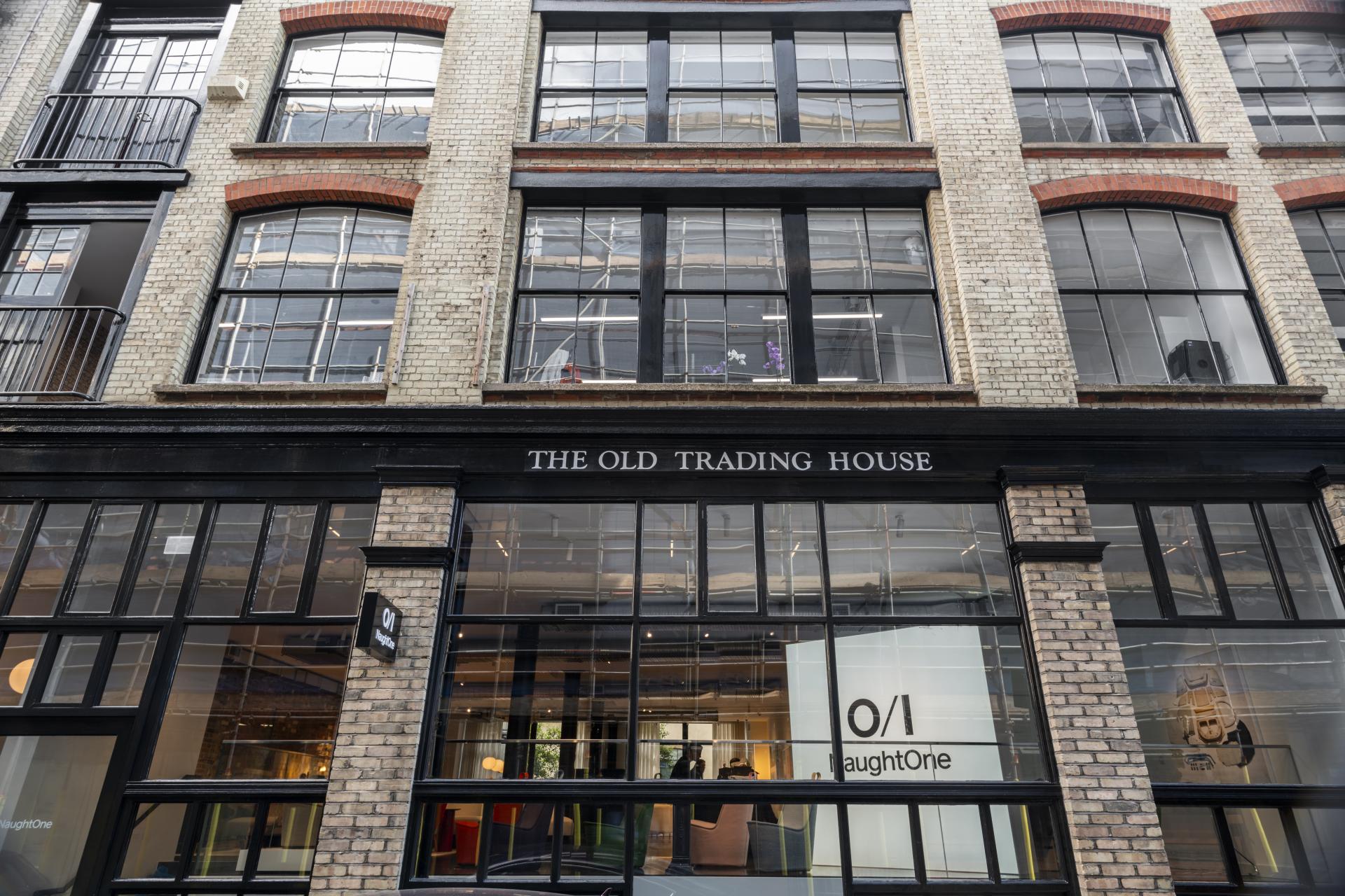 NaughtOne's flagship showroom entrance at The Old Trading House, showcasing a modern design and large glass windows.