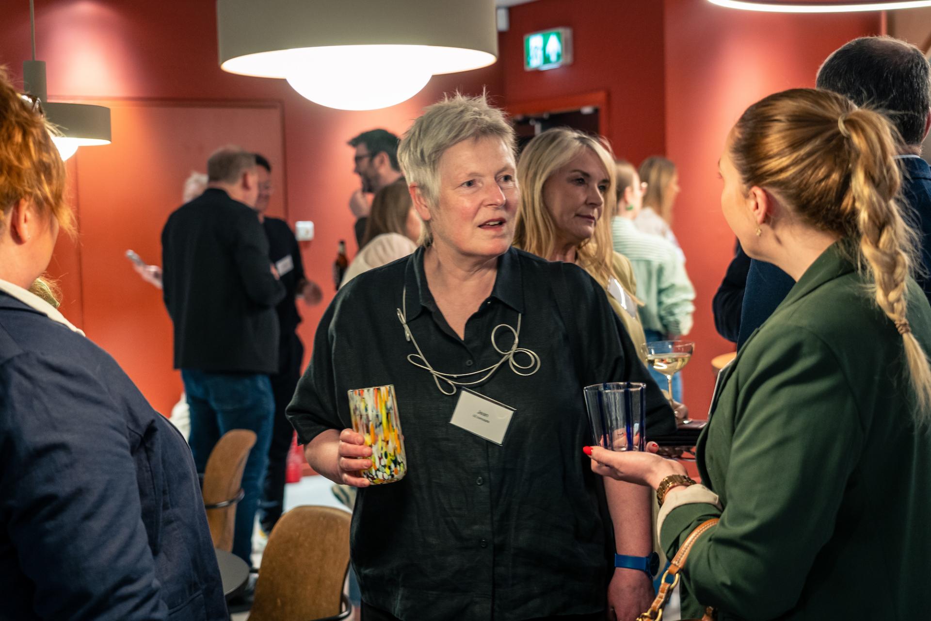 Networking event in Glasgow highlighting property outlook trends, featuring engaged participants discussing in a modern venue.