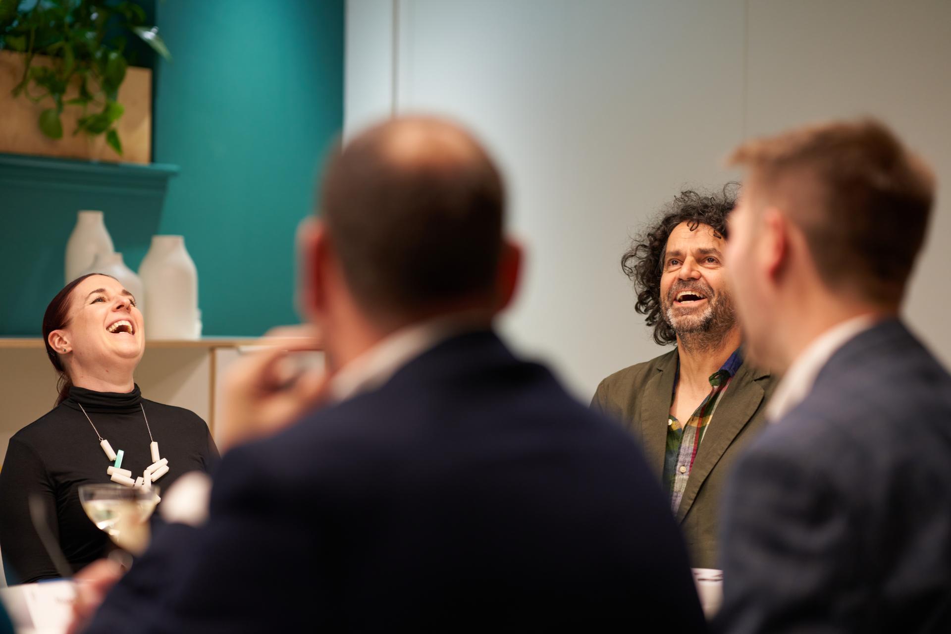 Participants laughing during the Glasgow Property Outlook seminar at Material Source Studio, discussing residential mix in the city.