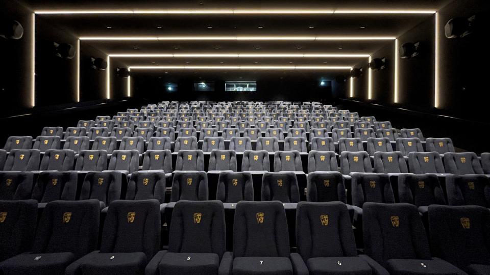 Modern BAFTA screening room with plush seats displaying BAFTA logos, designed by Benedetti Architects for a premium cinematic experience.