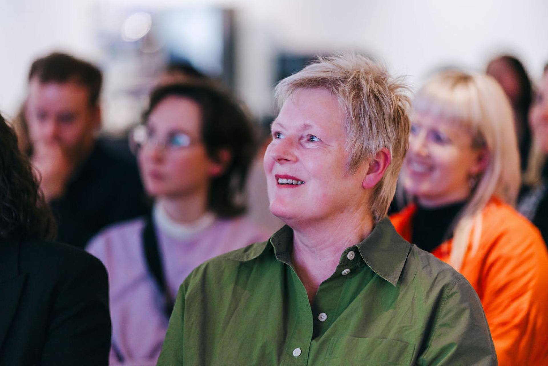 Audience members engaged during a lecture on sustainability at the University of Glasgow, featuring Professor Jaime Toney.