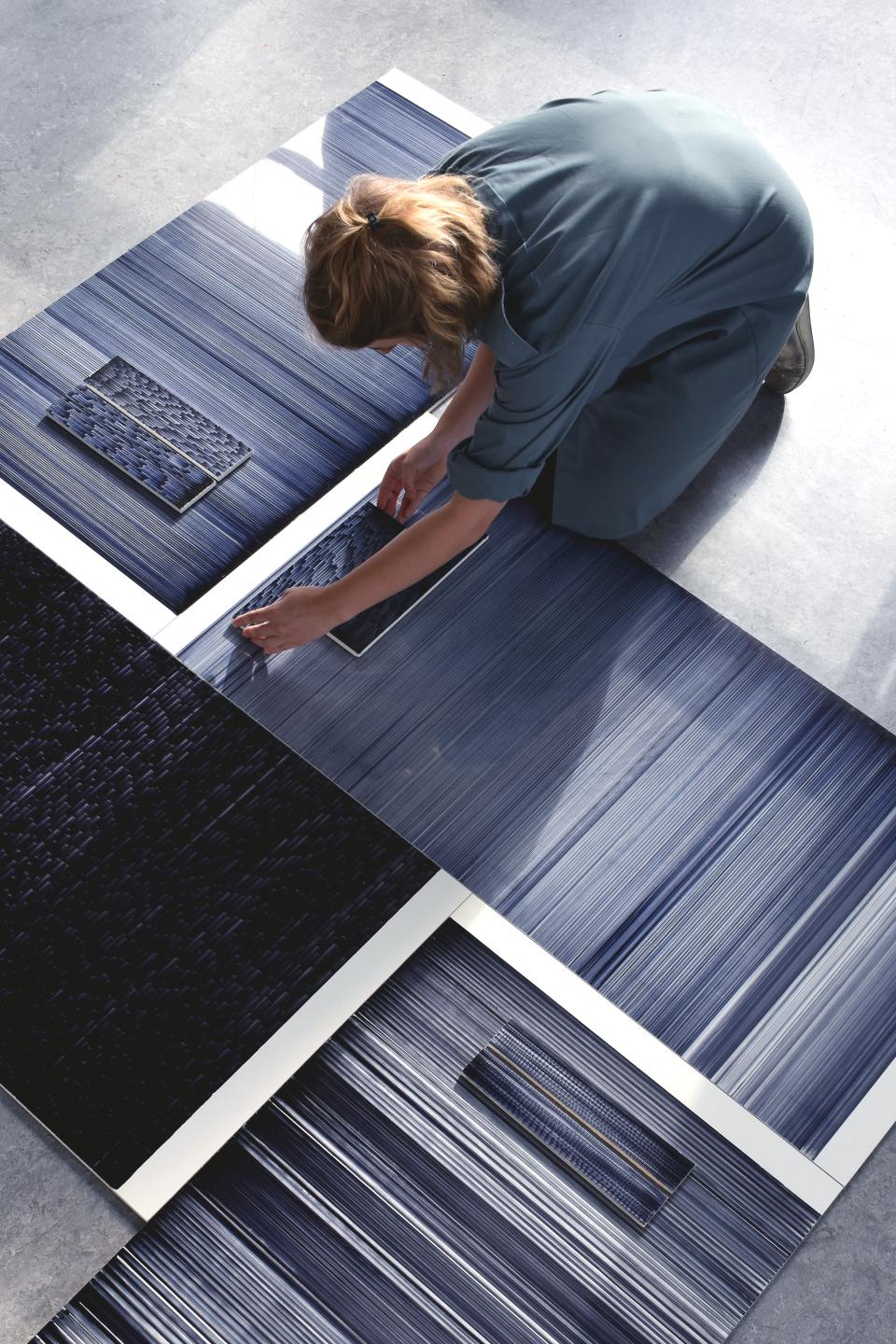 Designer Léa Mazy arranges innovative tile designs with intricate patterns and textures in calming blue tones.