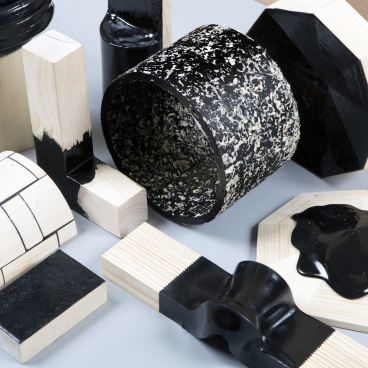 Assorted bio-based materials and design prototypes showcasing innovative black and natural wood textures.