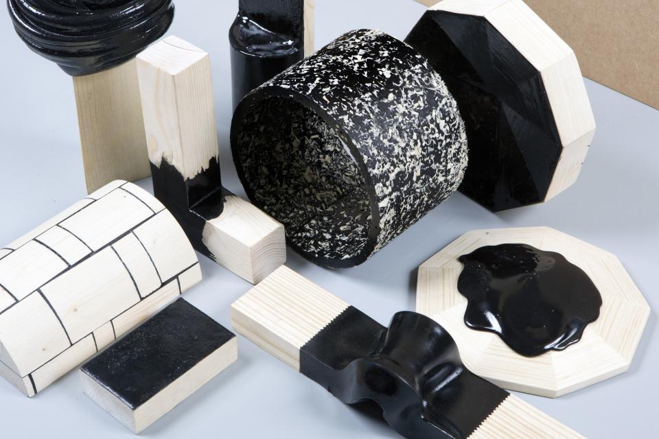 Assorted bio-based materials and design prototypes showcasing innovative black and natural wood textures.
