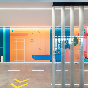 Vibrant office interior featuring colorful abstract murals and modern design elements, highlighting Modus' creative workspace for Travelfusion.