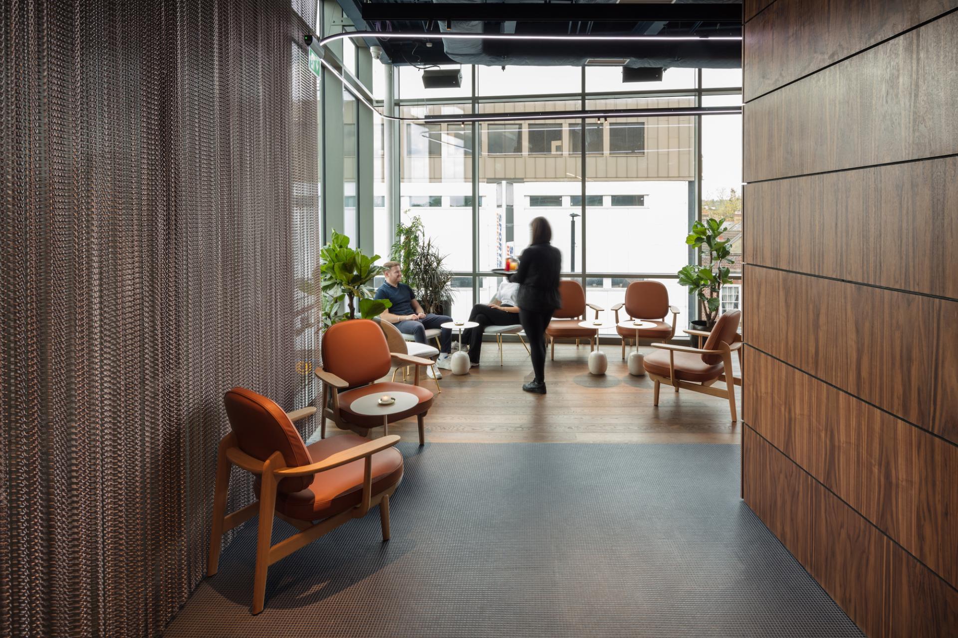 Stylish interior of M'Arks Sky Bar featuring modern seating and greenery, designed for relaxation and collaboration.