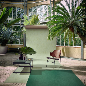 Forbo's Marmoleum Marbled collection showcased in a vibrant natural setting with plants and stylish, sustainable decor.