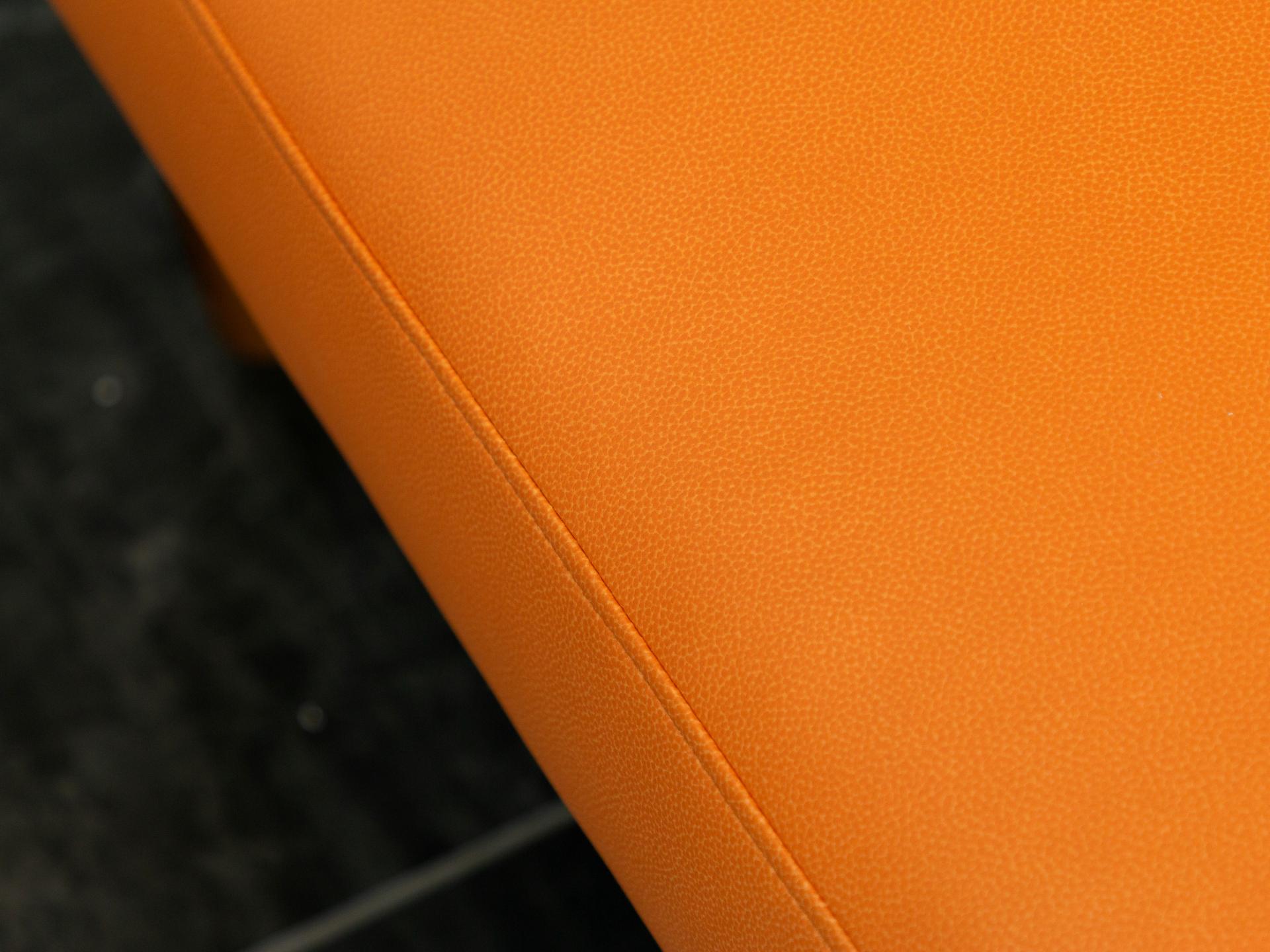 Close-up of vibrant orange Ultraleather® | Reef Pro fabric, showcasing its textured surface and animal-free design.