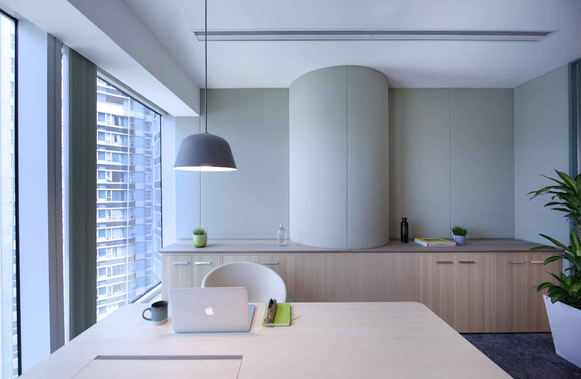 Modern workspace design with a desk, laptop, and plants, showcasing an agile office environment for Jardine Restaurant Group.