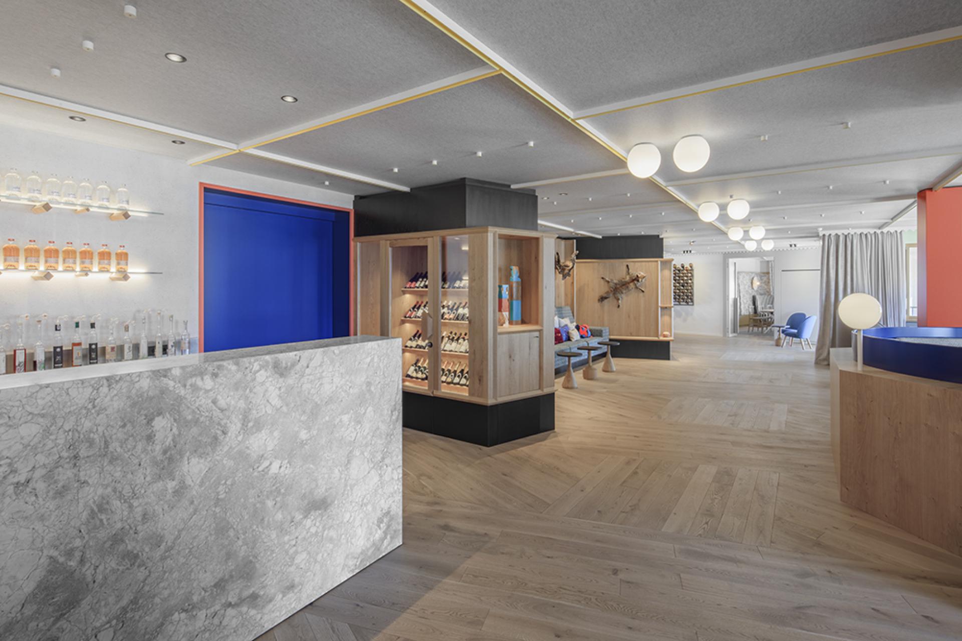 Modern hotel lobby with natural wood accents and contemporary decor, reflecting alpine heritage and design elegance.