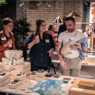 Visitors engage with biomimetic designs at From The Ground Up exhibition, showcasing innovative sustainable materials and creative displays.