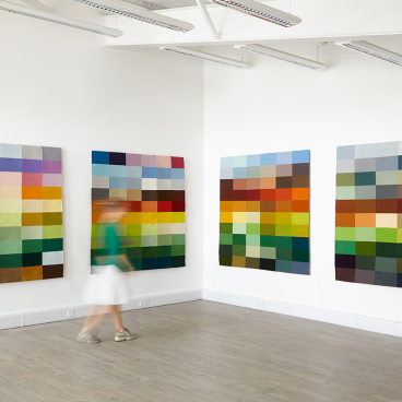 Colorful textile wall art installations reflecting the rural hues of Wiltshire, showcasing Justine Randall's landscape tapestry themes.