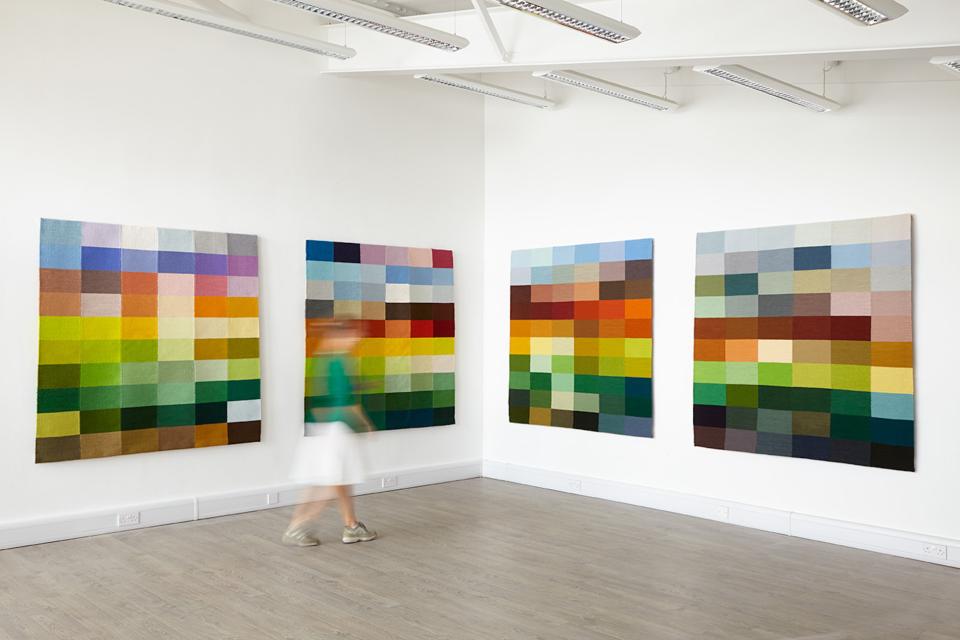 Colorful textile wall art installations reflecting the rural hues of Wiltshire, showcasing Justine Randall's landscape tapestry themes.