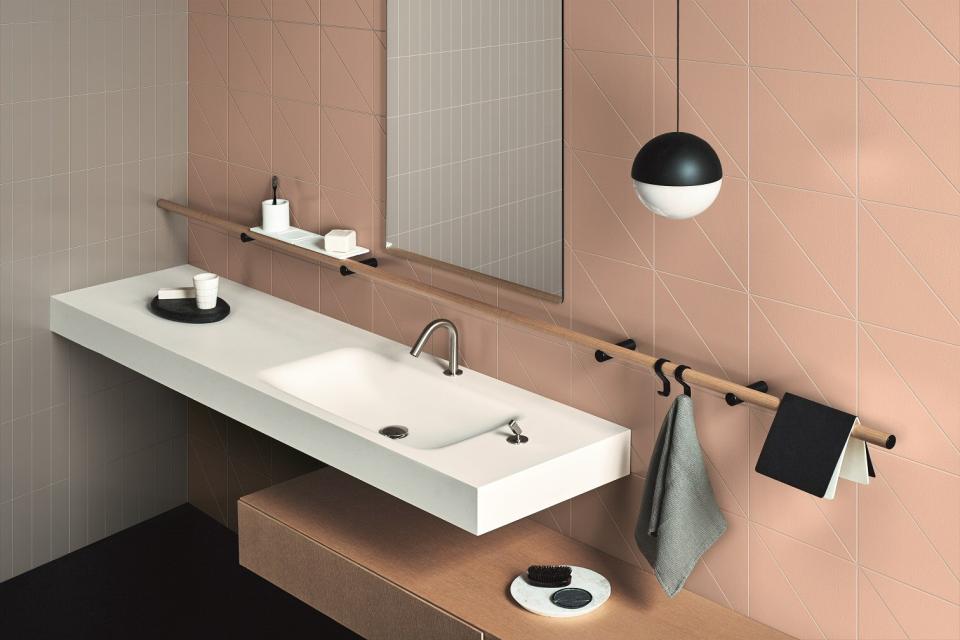 Modern bathroom featuring Pittorica's colorful porcelain tiles, a sleek vanity, and stylish accessories by Studiopepe.