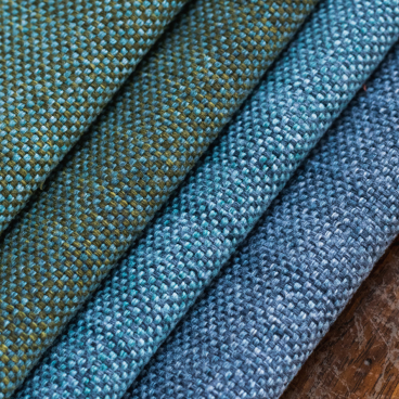 Upholstery fabric samples from Agua's VerdEco collection, showcasing textures and colors made from 100% upcycled textile waste.