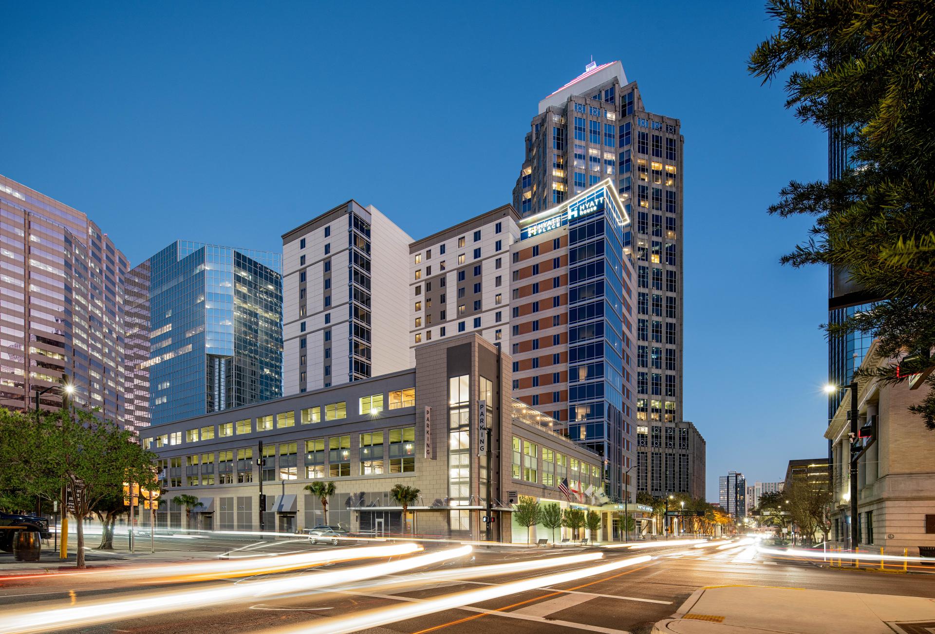 Hyatt House in vibrant Tampa skyline featuring modern architecture and colorful lighting at dusk.