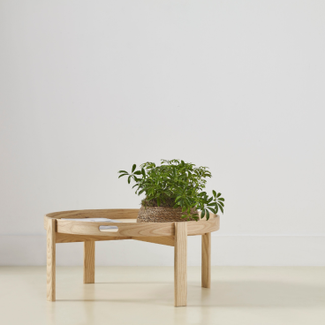 Wooden coffee table from the Ori Collection featuring a plant holder, designed by Another Country and Ekkist.