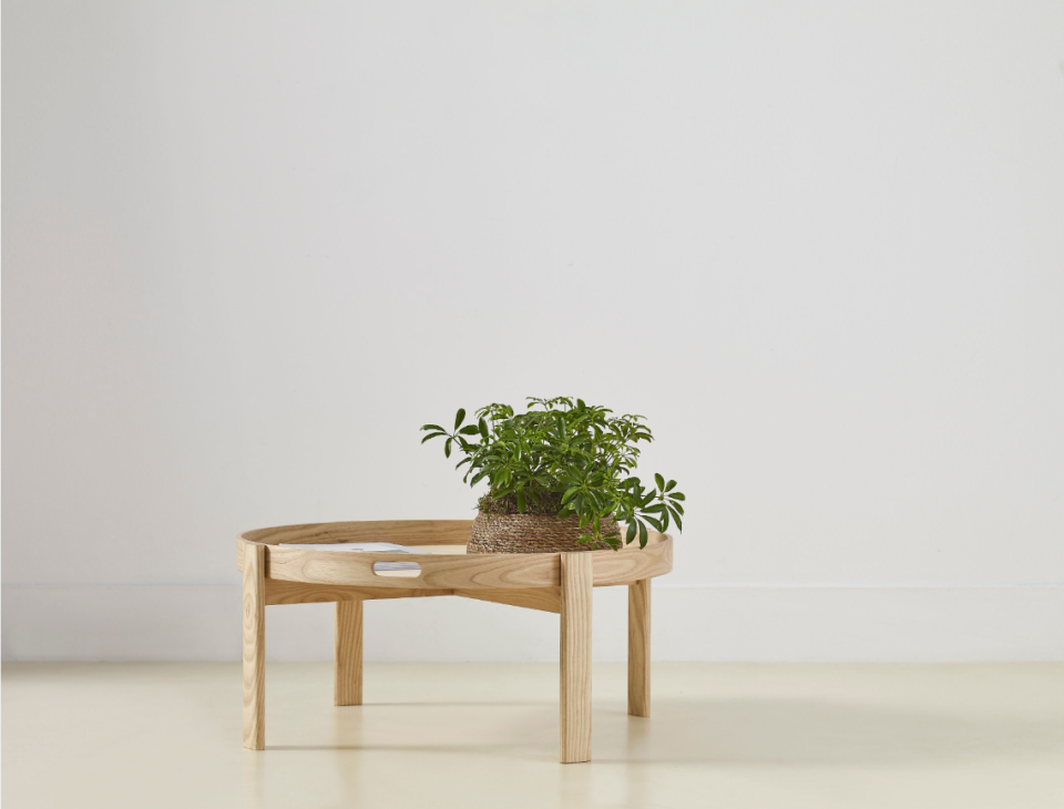 Wooden coffee table from the Ori Collection featuring a plant holder, designed by Another Country and Ekkist.