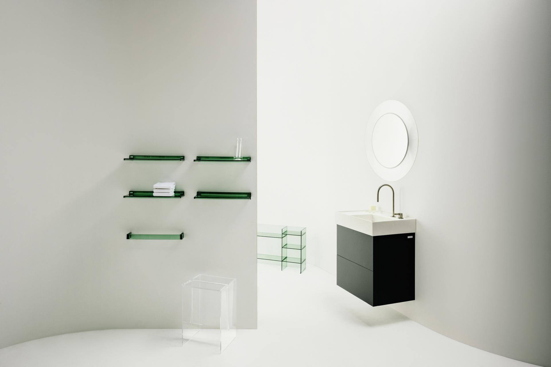 Modern bathroom design featuring a sleek black sink, elegant mirror, and minimalist green shelving.