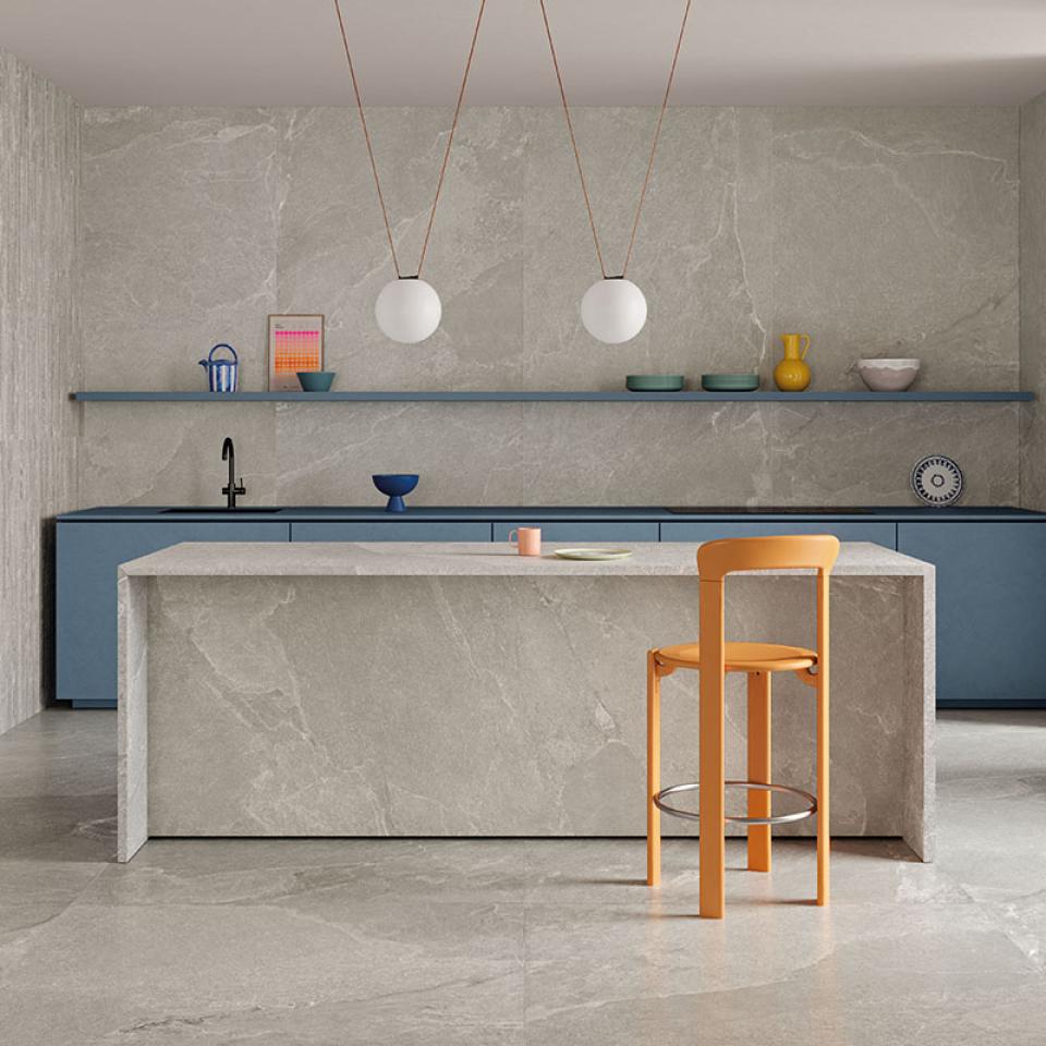 Contemporary kitchen featuring Grestec's Cellan collection with slate-inspired surfaces, modern furniture, and minimalist decor.