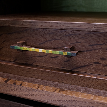Intricately designed cabinet drawer featuring a colorful, decorative handle by furniture maker Kevin Stamper, inspired by Madeira.