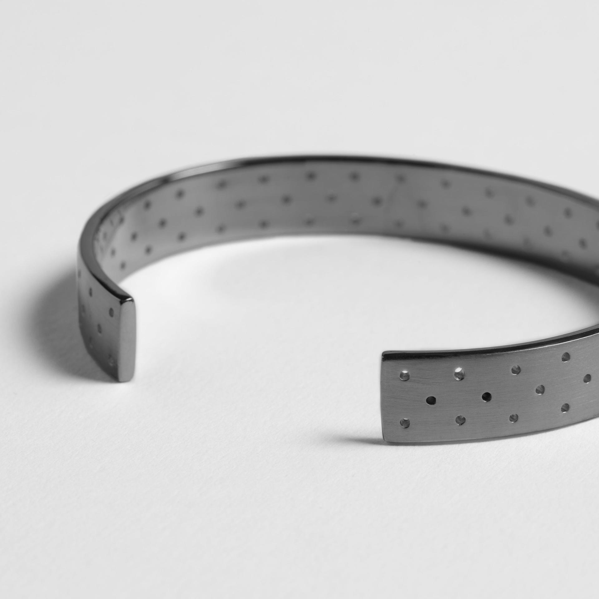 Stylish metallic cuff bracelet featuring a unique dotted pattern, showcased at designjunction on London's South Bank.