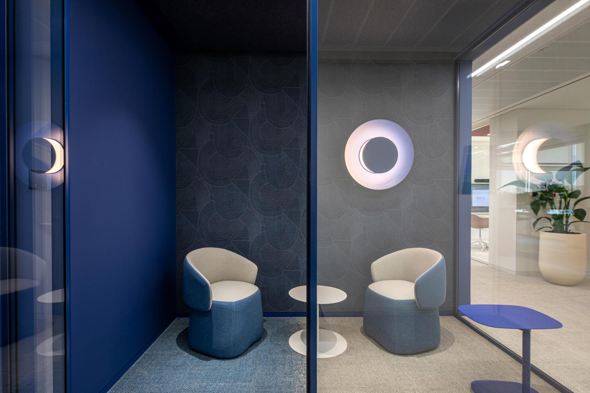 Vibrant office nook featuring cozy chairs, modern decor, and colorful walls inspired by Dubai's cultural landscapes.