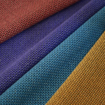 Vibrant swatches of Camira's Craggan Flax fabric showcasing sustainable, textured textiles in rich colors.