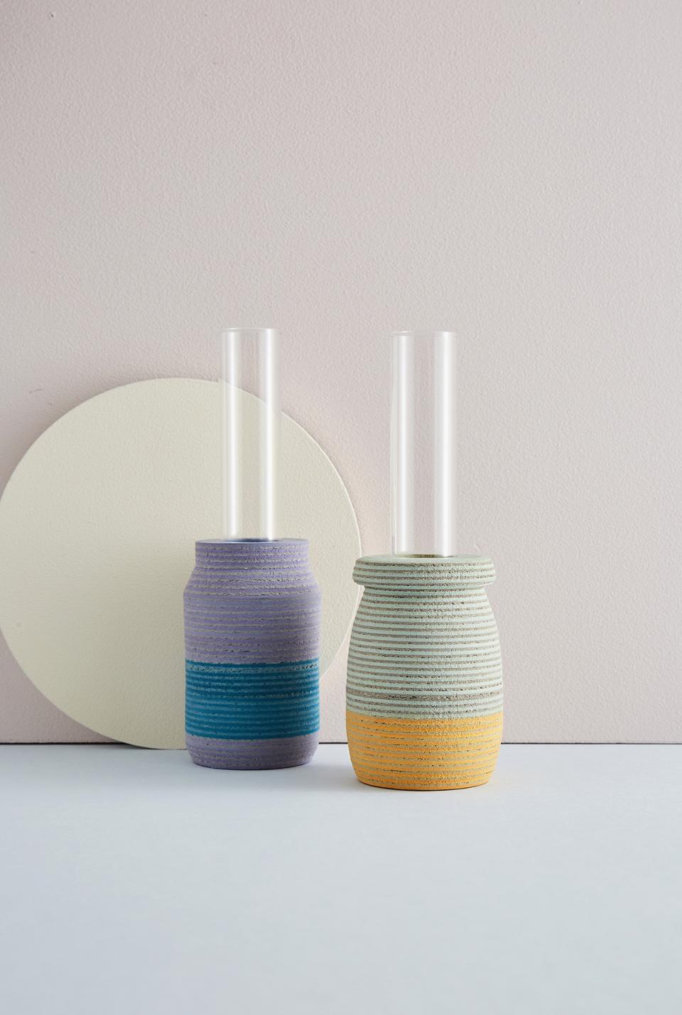 Colorful contemporary vases with glass tubes, showcasing innovative design by emerging talent at the New Designers event.